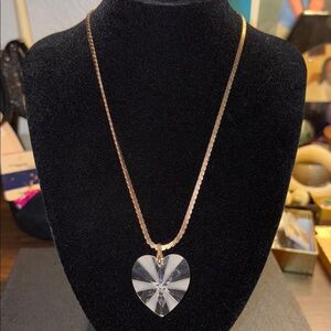clear crystal heart pendant necklace featuring  on a gold chain.